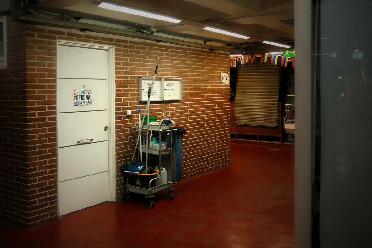 A cleaning cart set up in an industrial hallway before a shift